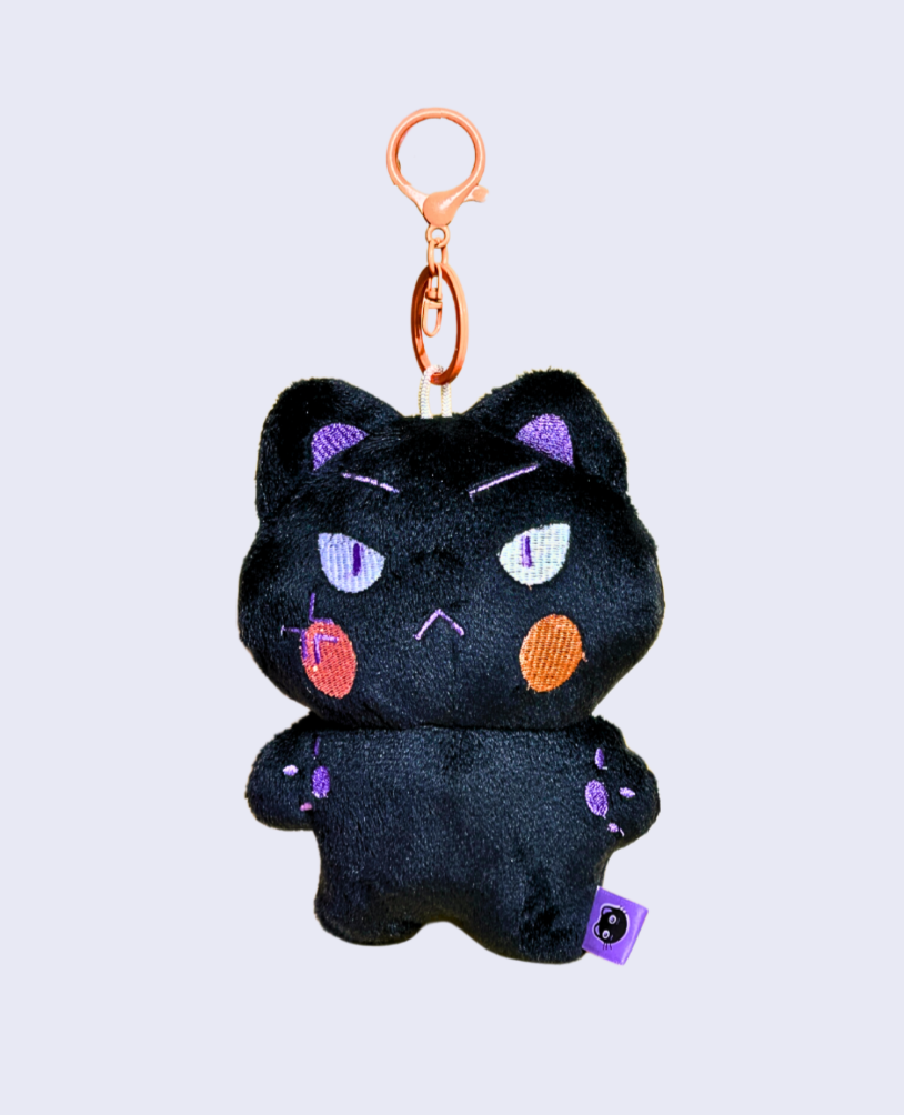 Black cat plush keychain with colorful accents on a light gray background