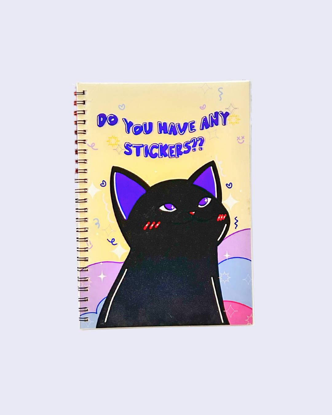 A reusable sticker book with a spiral binding and a cover featuring an illustration of a black cat with purple ears. The title 'Do you have any stickers?' is displayed on the cover.