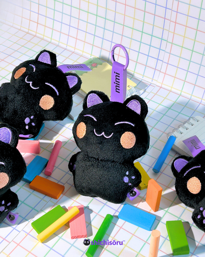 Black cat plush toys with purple accents on a colorful grid background